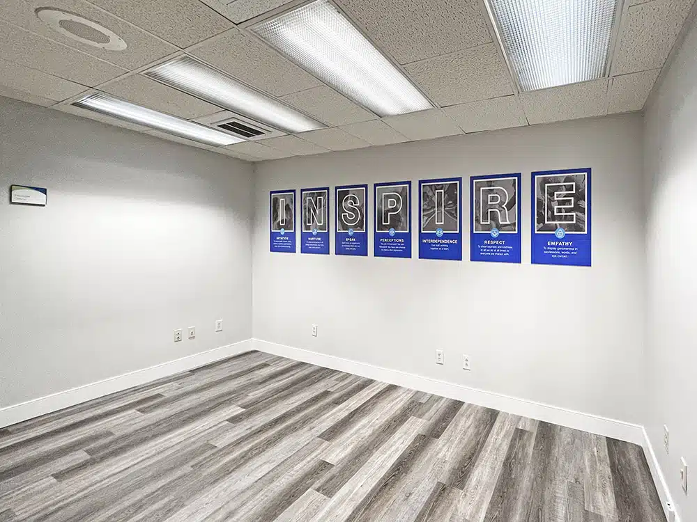 Empty room with Inspire posters displayed on wall