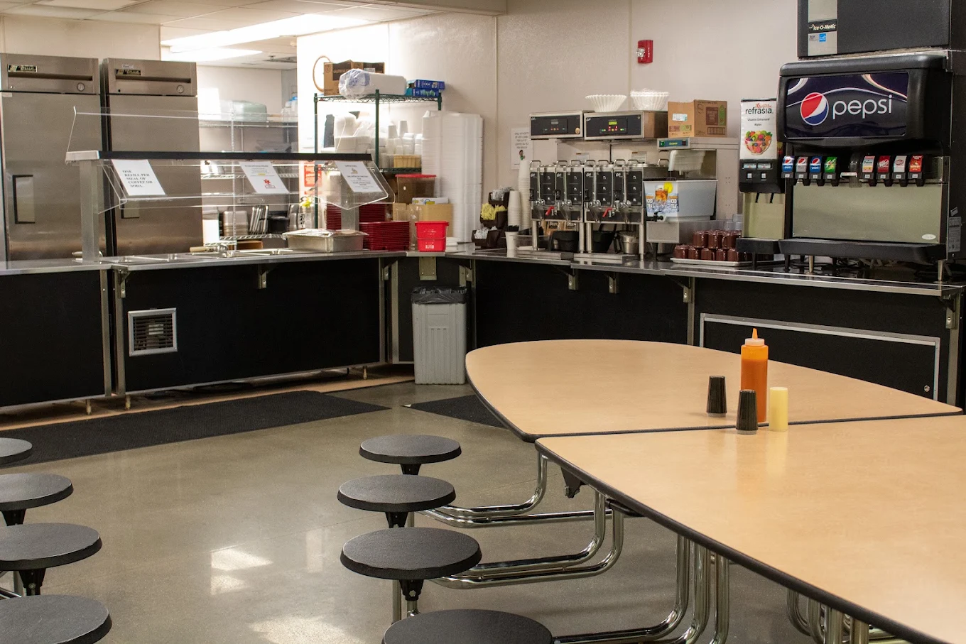 Dining area with tables and beverage station
