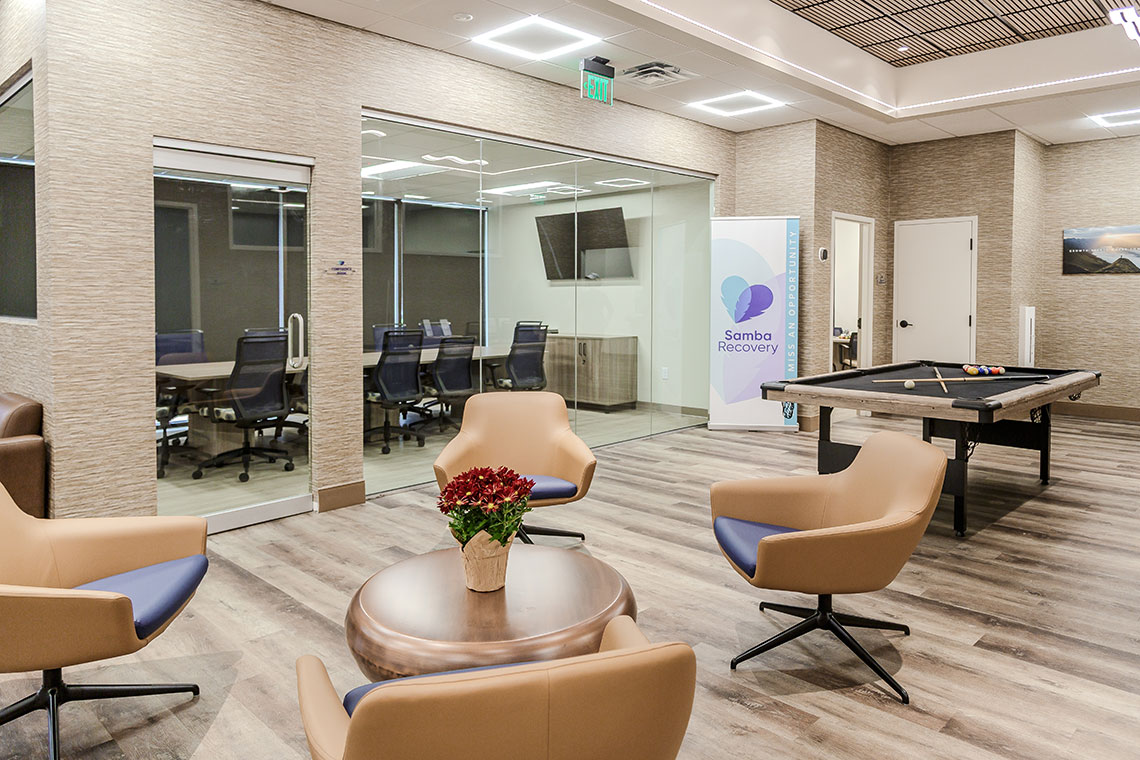 Indoor seating area with chairs near large windows