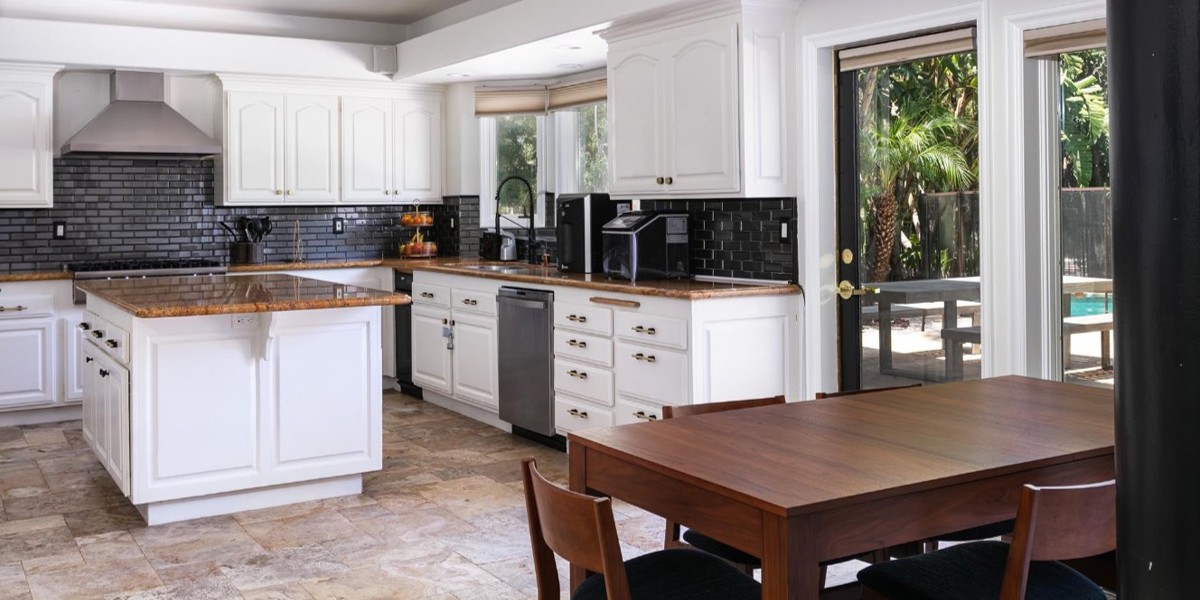 Modern kitchen with dining table and outdoor patio access