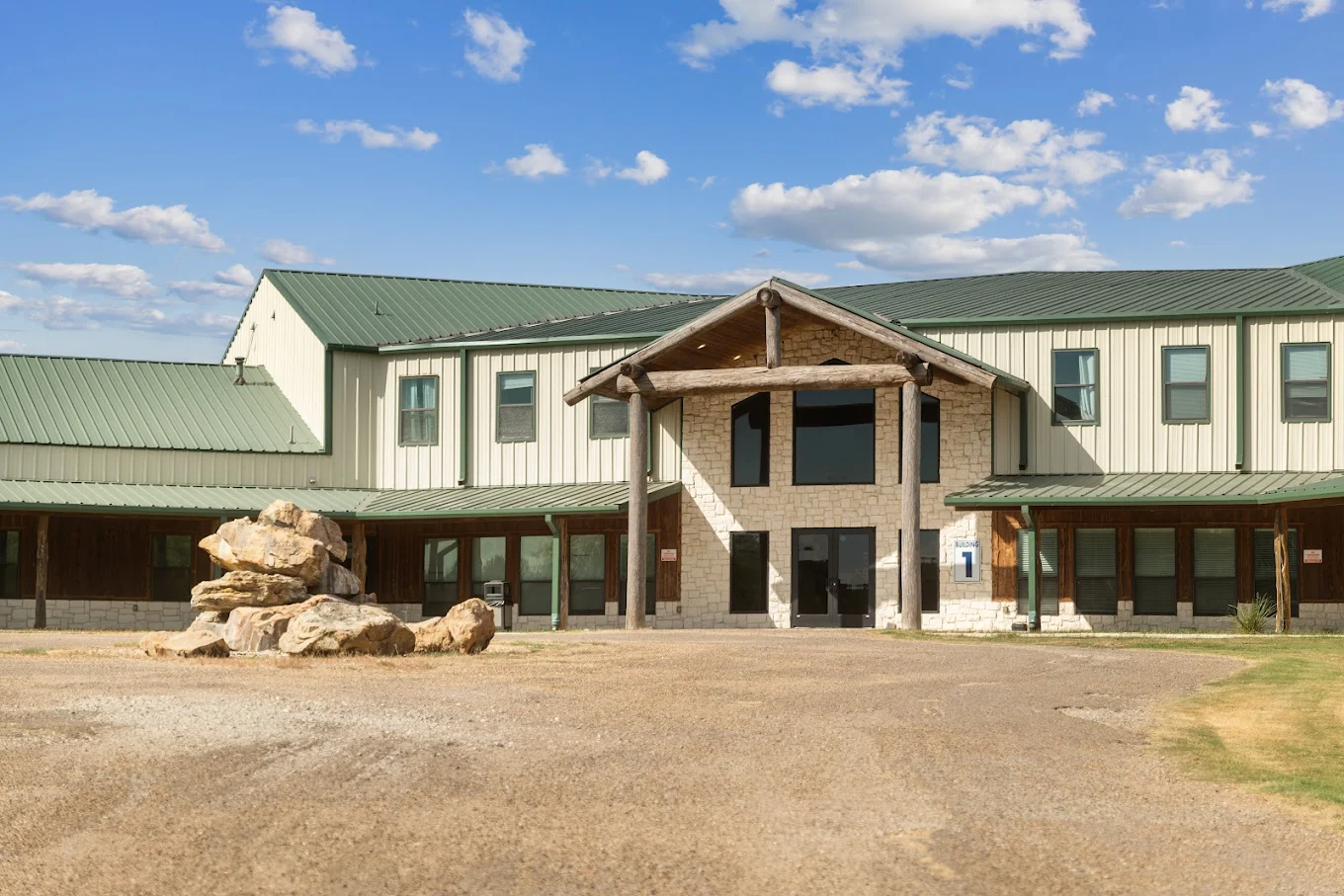 Stone and metal building entrance with green roof