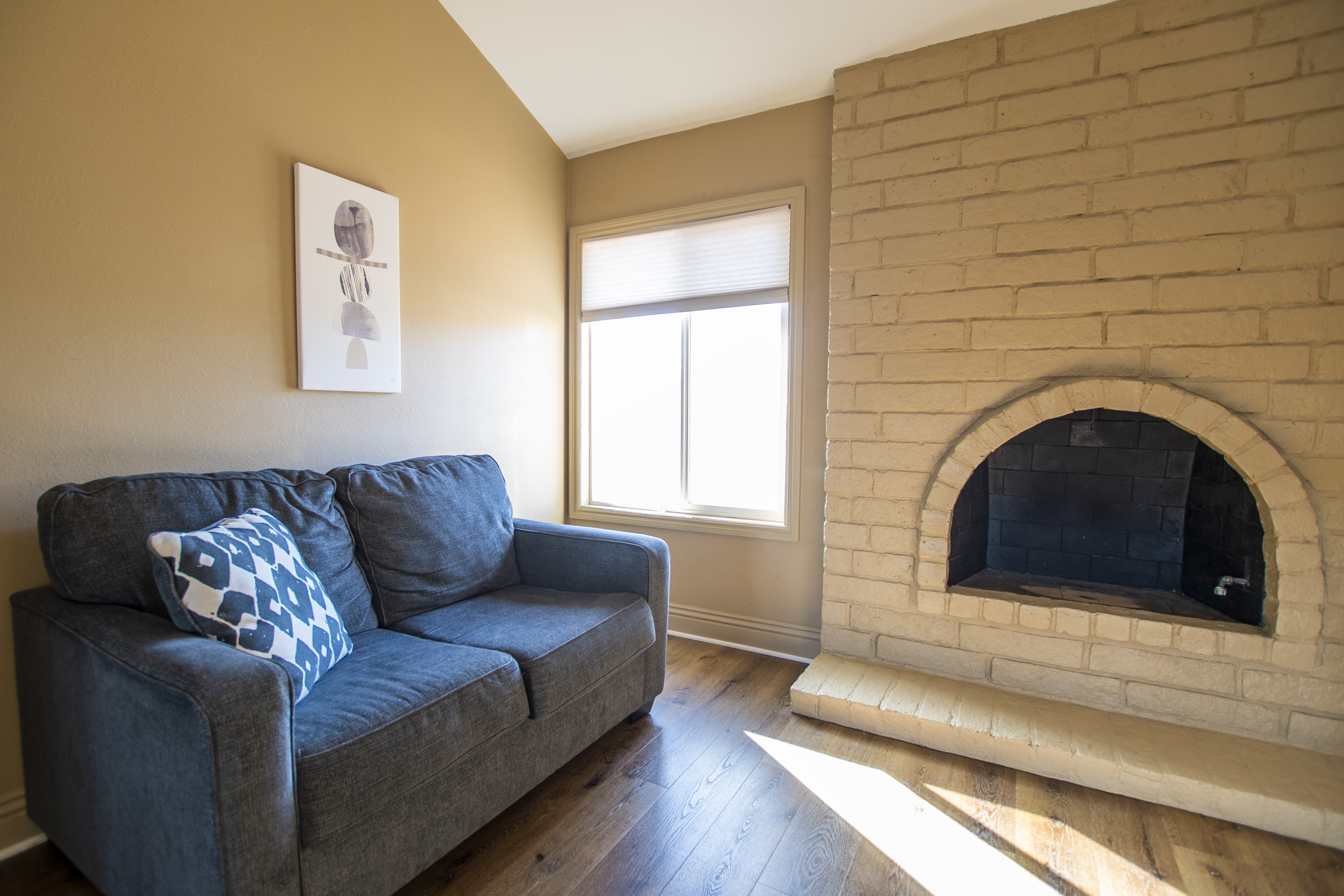 Small sofa next to a built-in fireplace