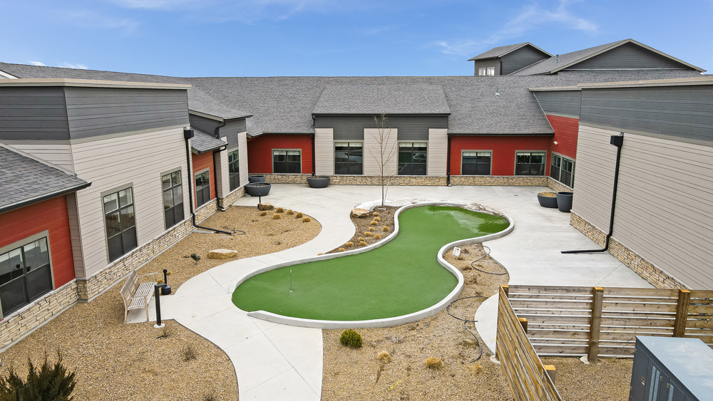 Outdoor putting green in the facility courtyard