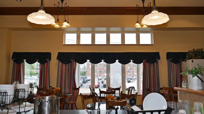 Dining area with tables and large front windows