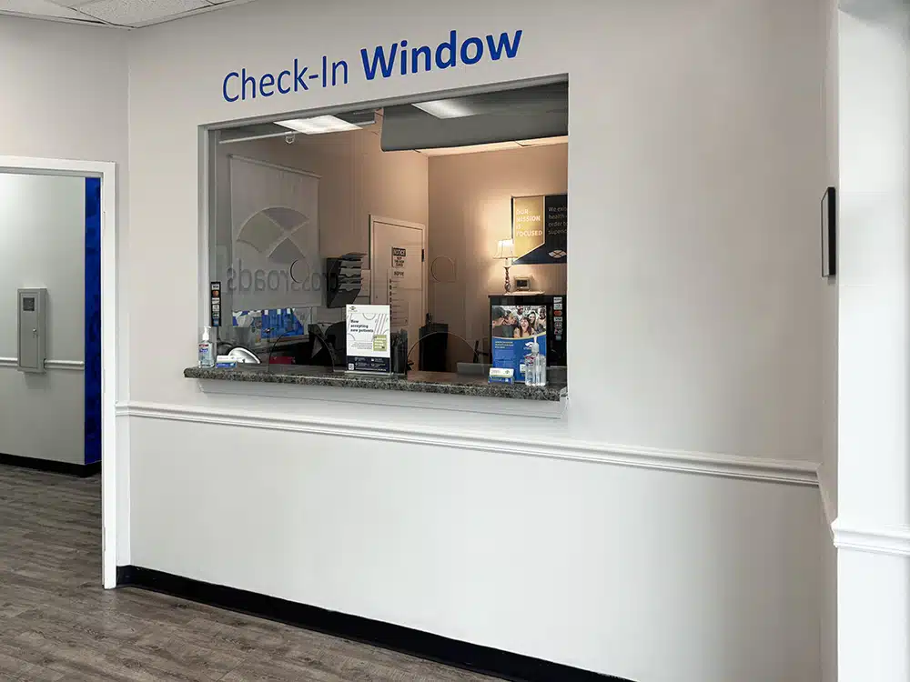 Check-in window with counter and office behind glass