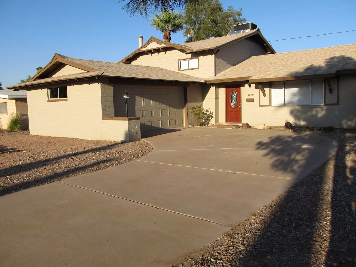 Home entrance with driveway and garage