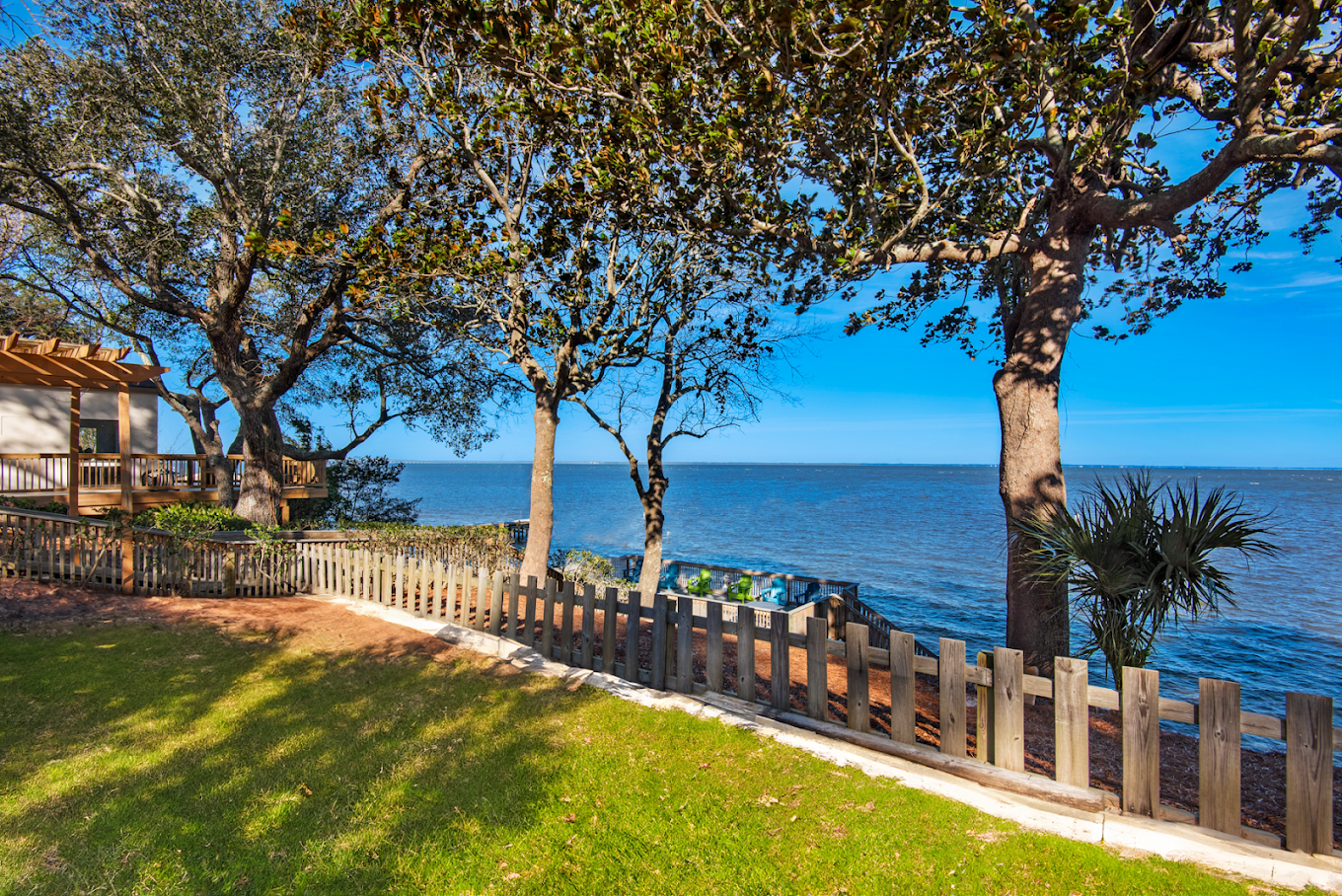 Grassy grounds with mature trees overlooking the water