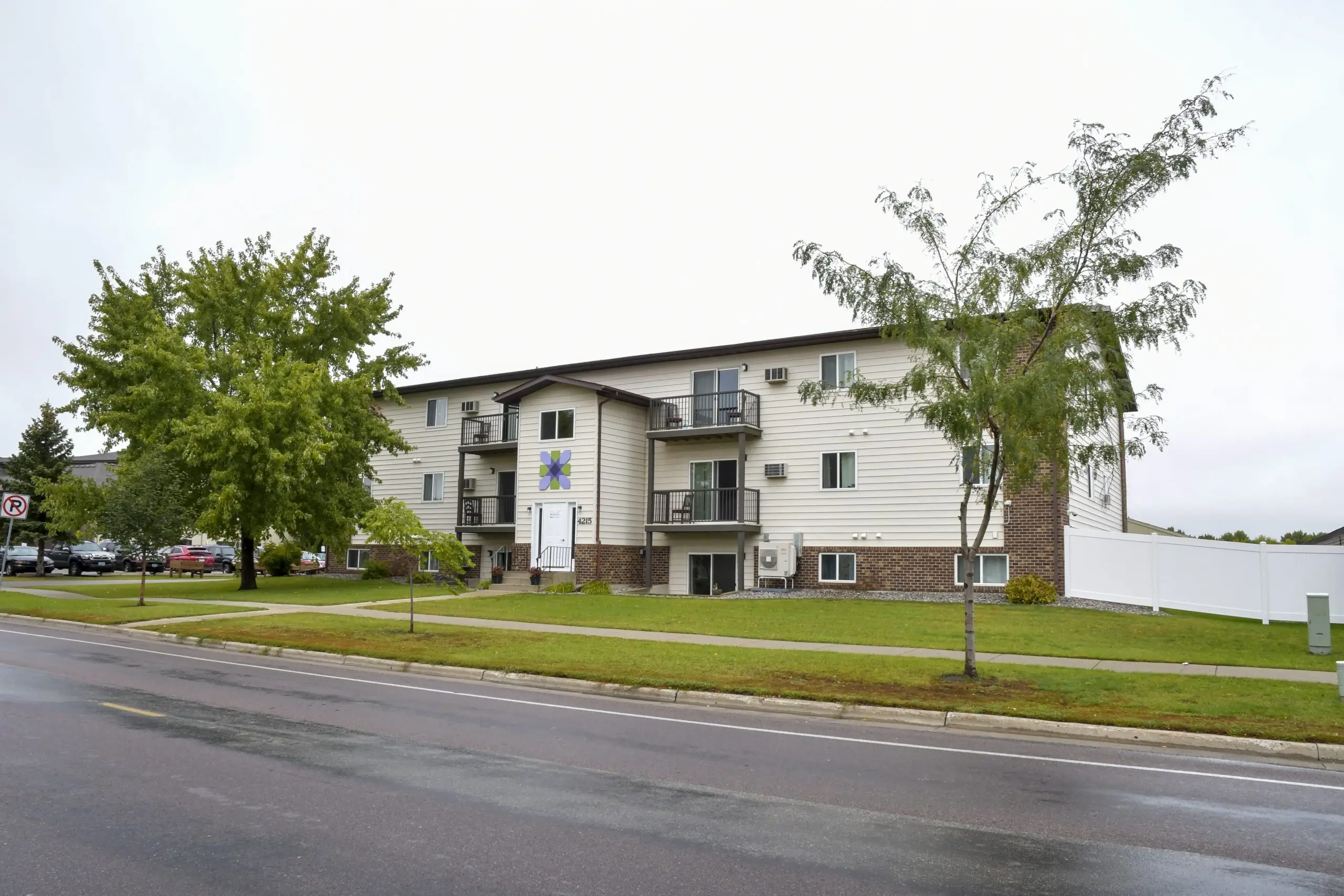 Rehab residence with brick siding and outdoor balconies