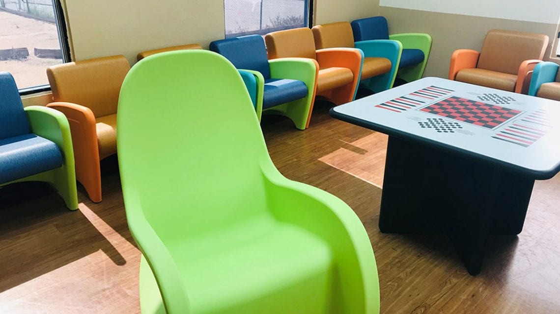 Colorful chairs and table in hospital game room