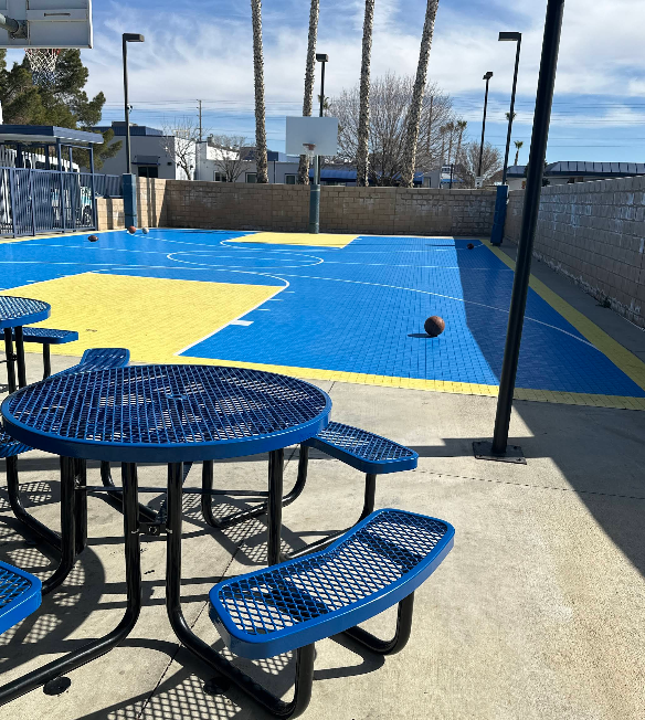 Outdoor basketball court with blue and yellow flooring
