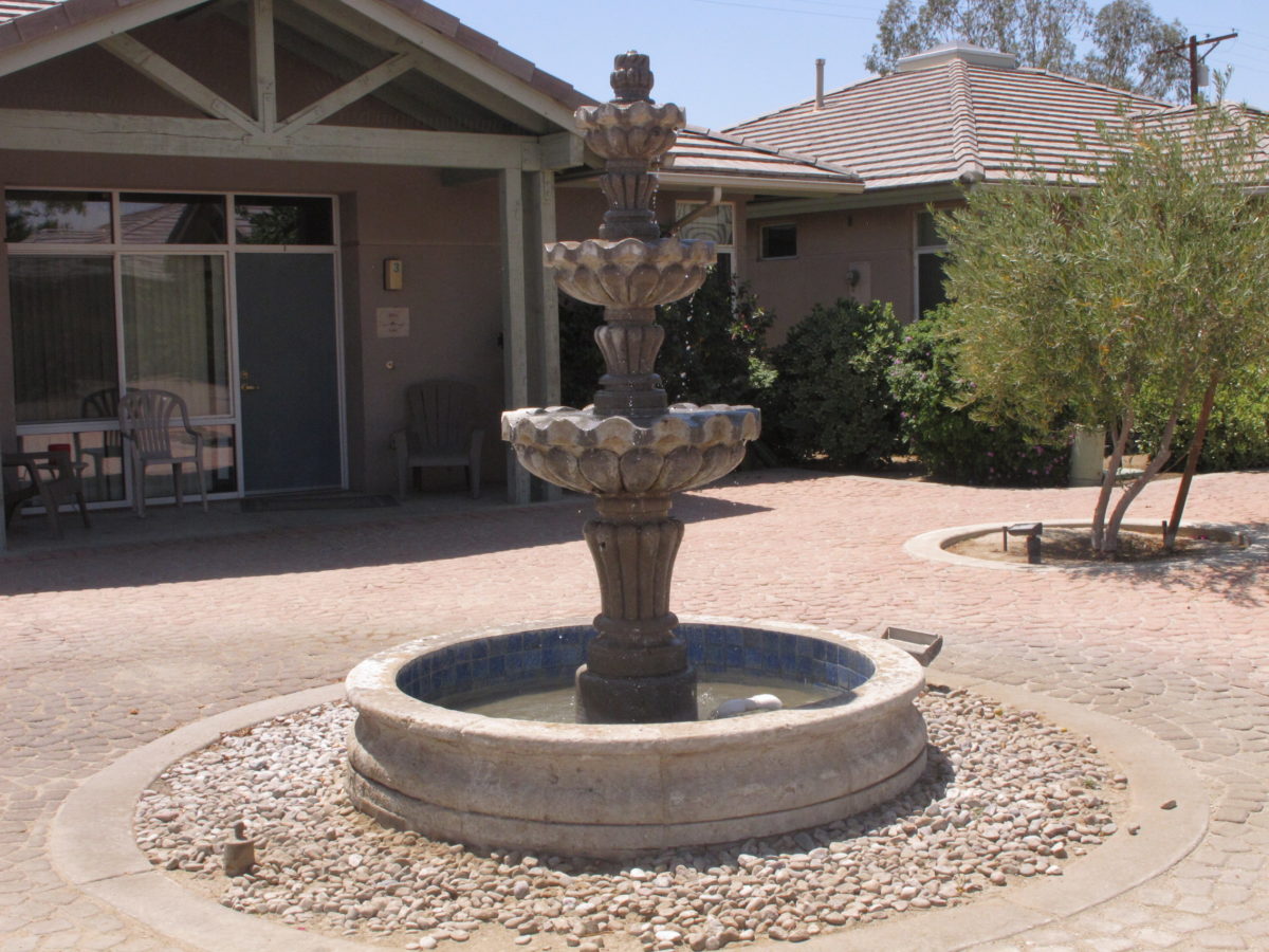 Tiered stone fountain in rehab facility courtyard.