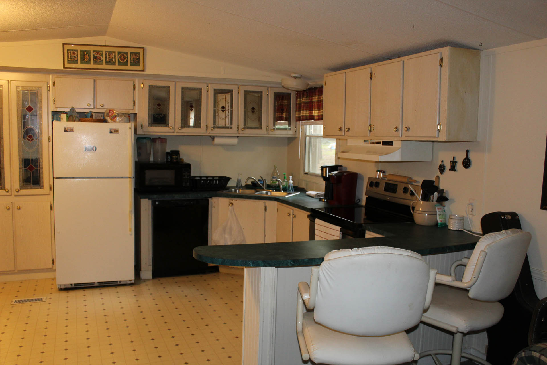 Shared kitchen with appliances and dining counter seating
