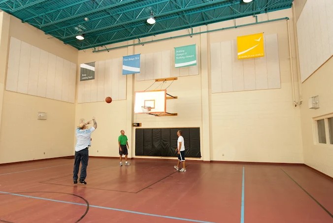 Indoor basketball court with patients playing in gym