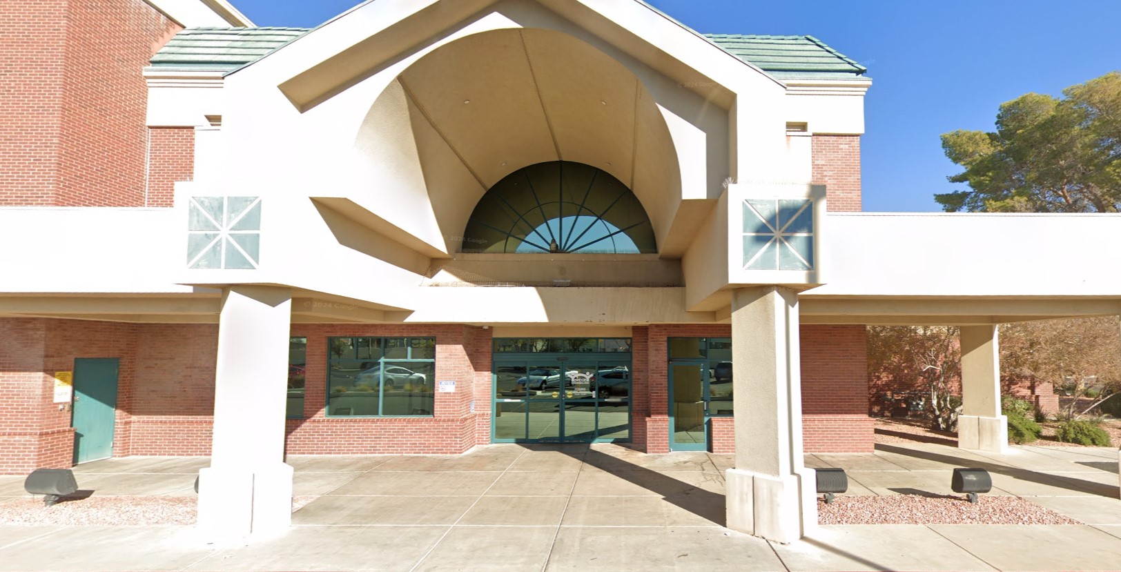 Modern entrance to Bridge Counseling Associates, featuring a large archway and glass doors, welcoming clients.