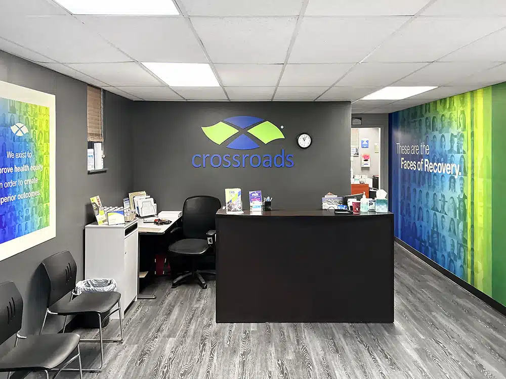 Reception desk with Crossroads logo and mural wall