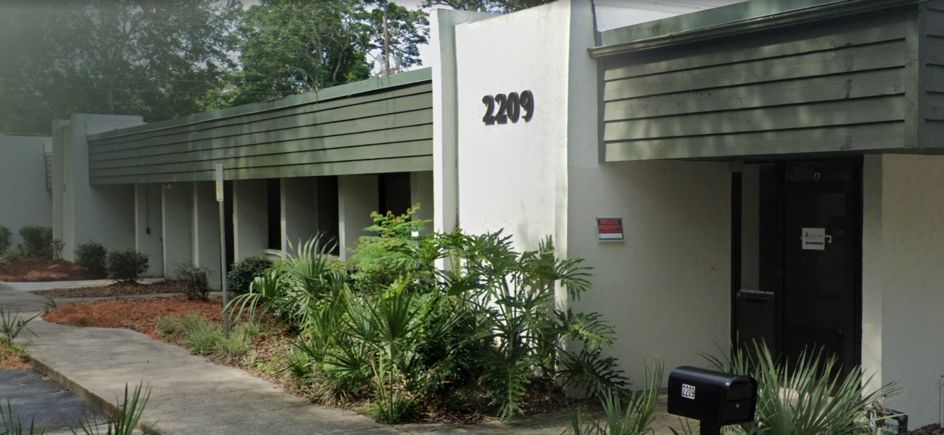 Facility entrance with paved walkway.