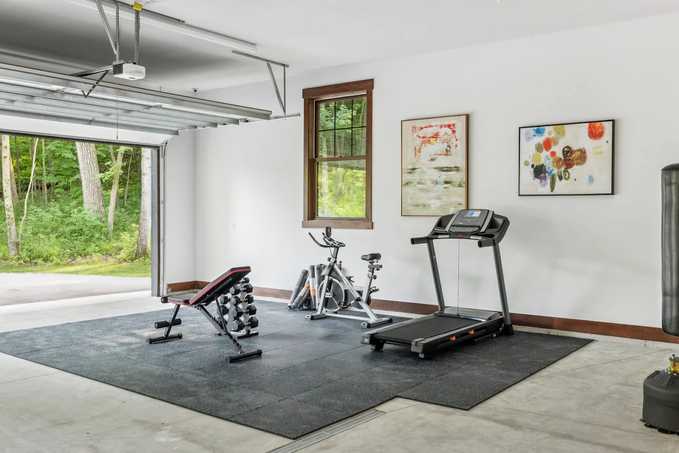 Gym setup with treadmill, bike, and weights
