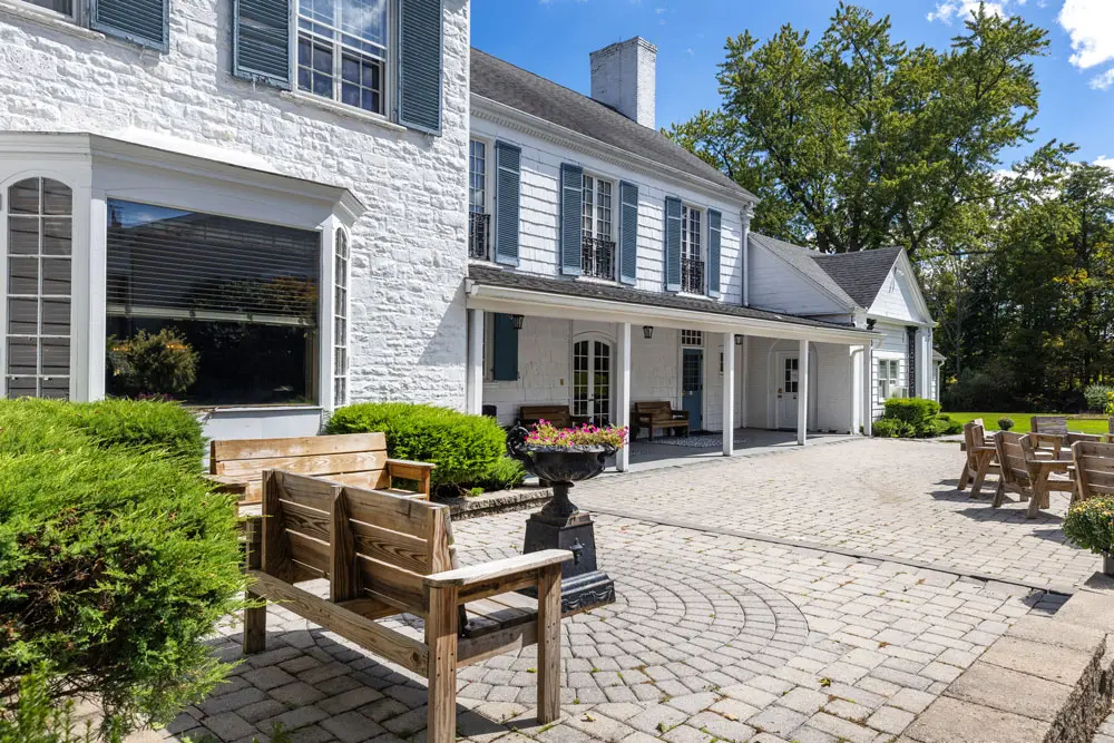 Stone courtyard with benches and landscaped gardens