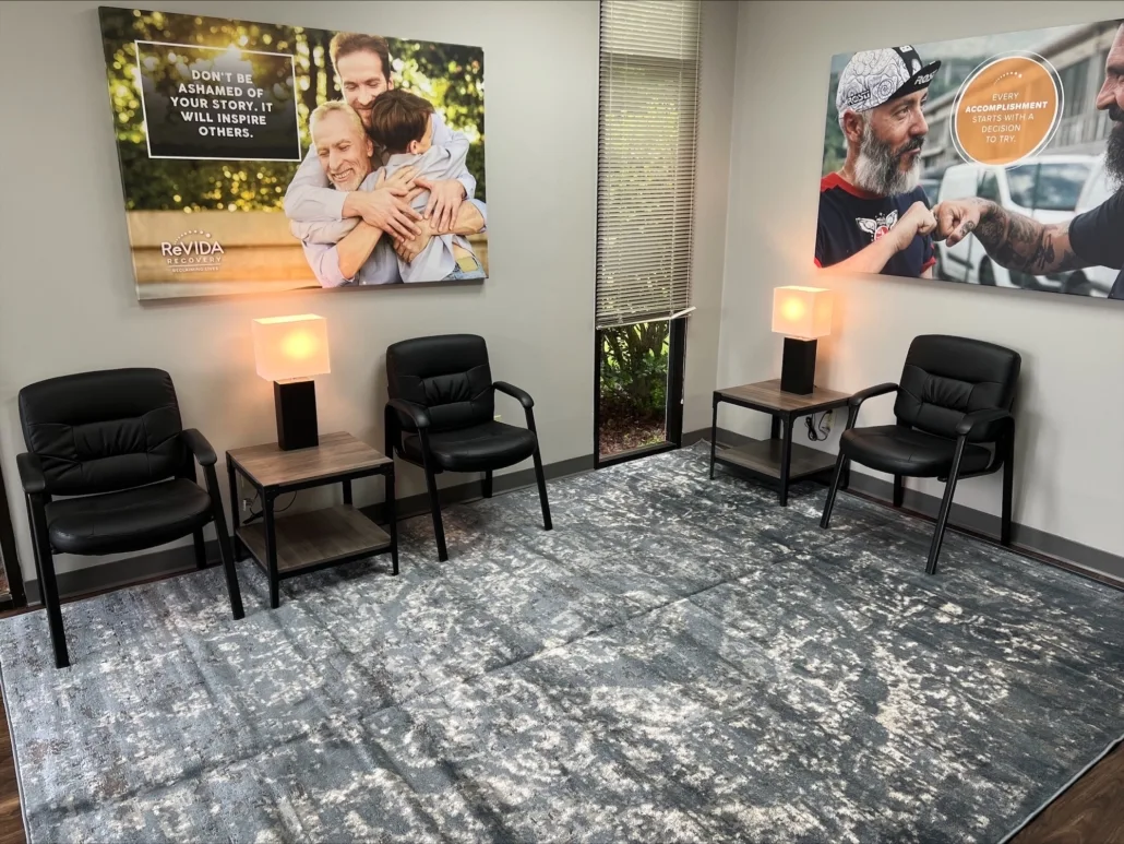 Waiting room with chairs, lamps, and motivational wall art