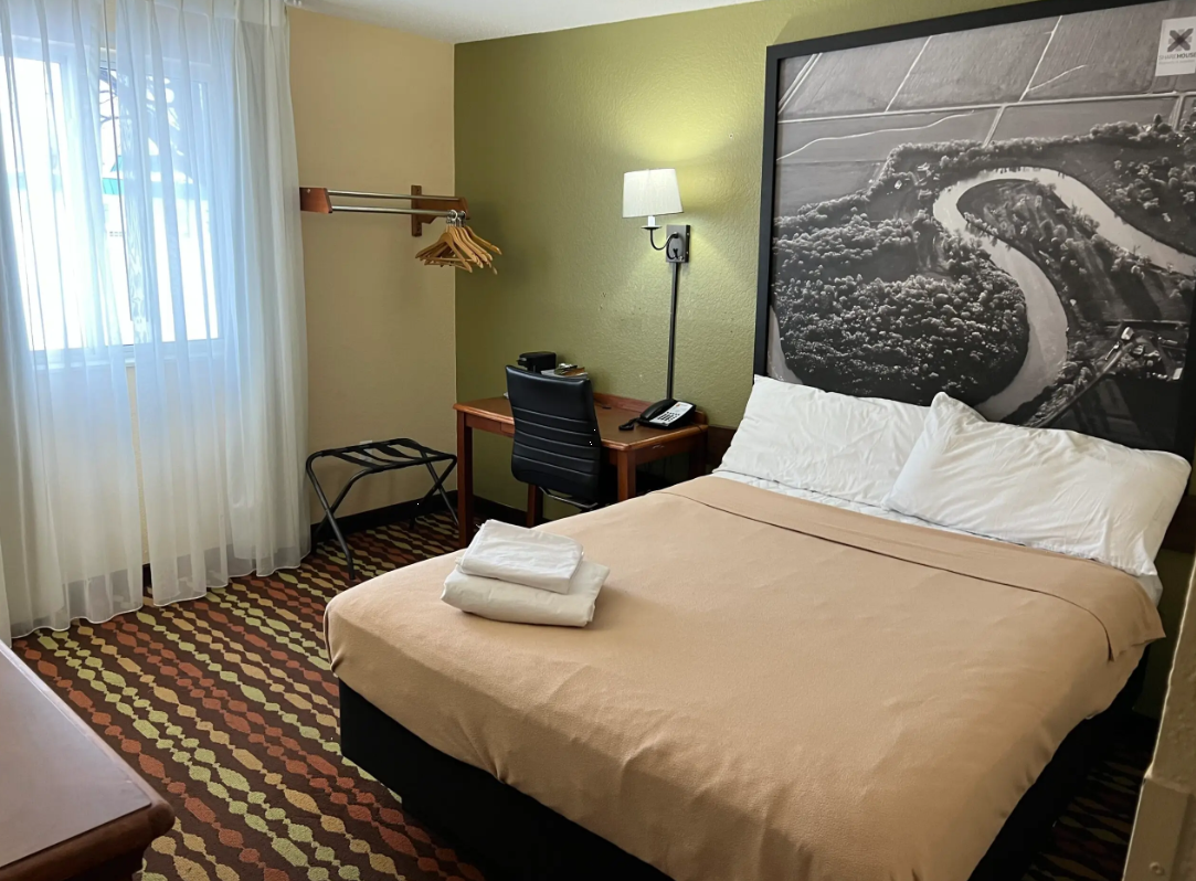 Private bedroom with desk, bed, and window for natural light
