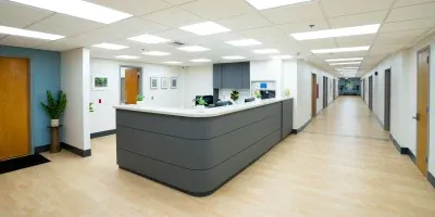 Clean hallway with modern central nursing station.