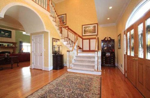 Elegant foyer with staircase and wood flooring