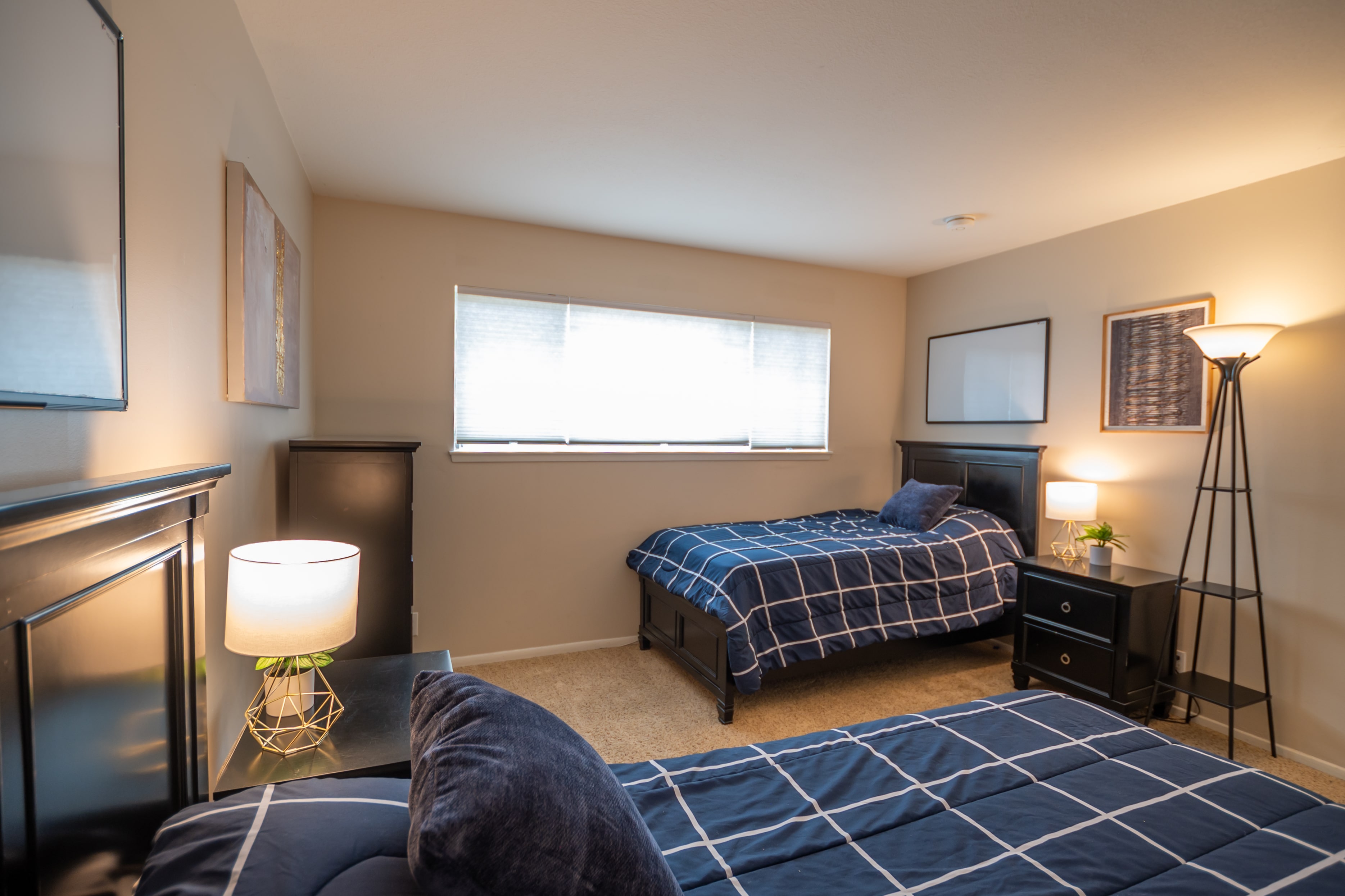 Bedroom with two twin beds and wall art