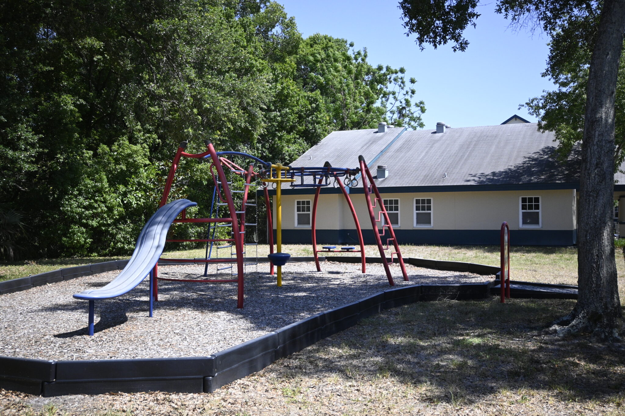 Outdoor playground with slide and climbing equipment at facility