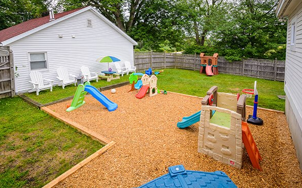 Fenced playground with slides and play structures
