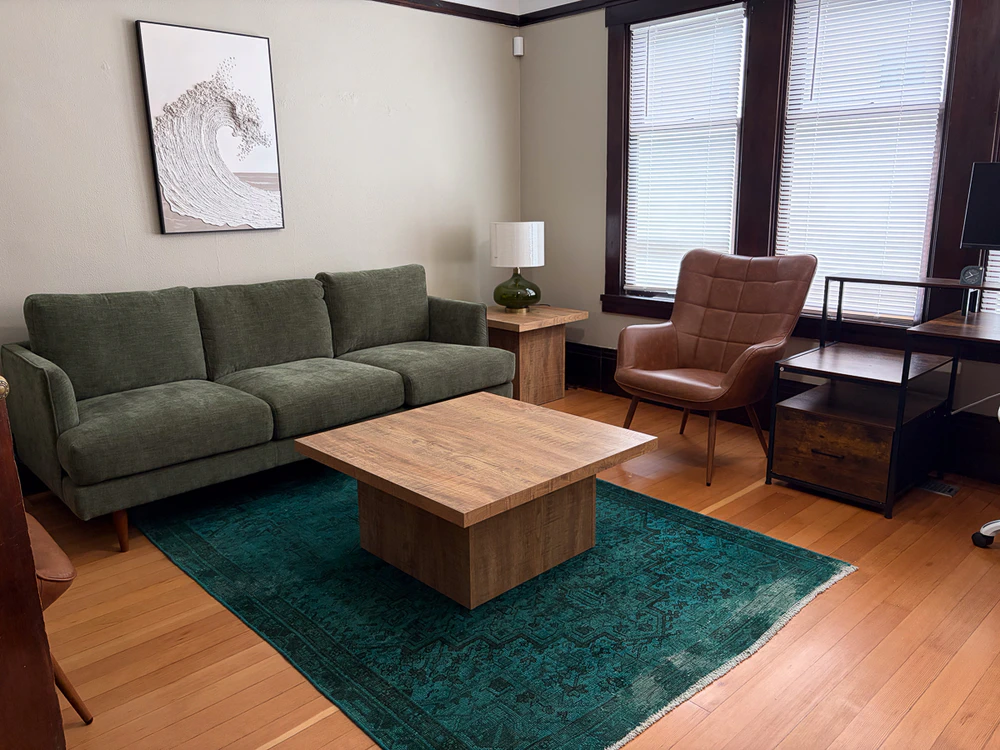 Counseling room with sofa, chair, and desk