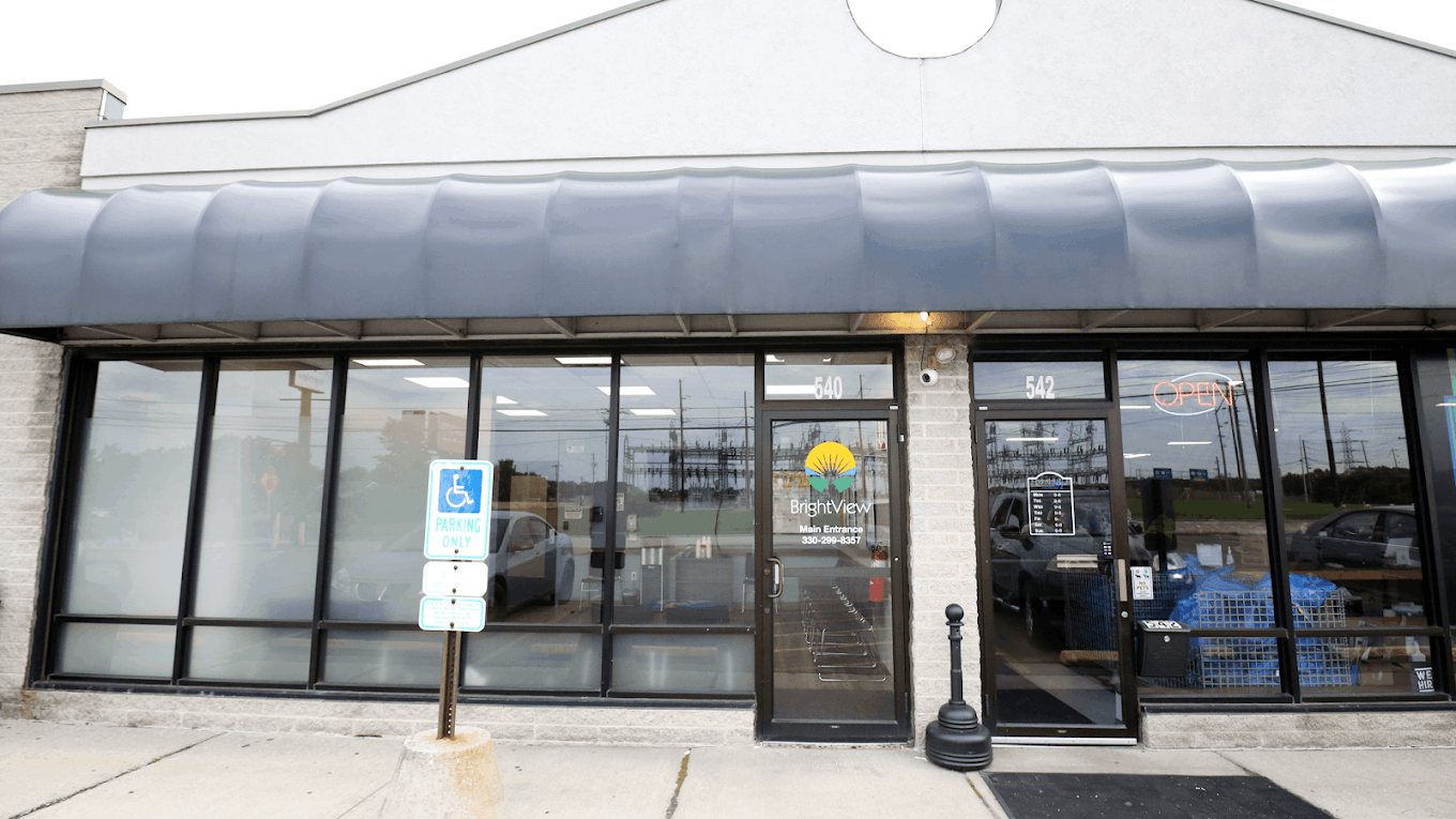 BrightView Elyria treatment center exterior with glass storefront, accessible parking sign, and main entrance