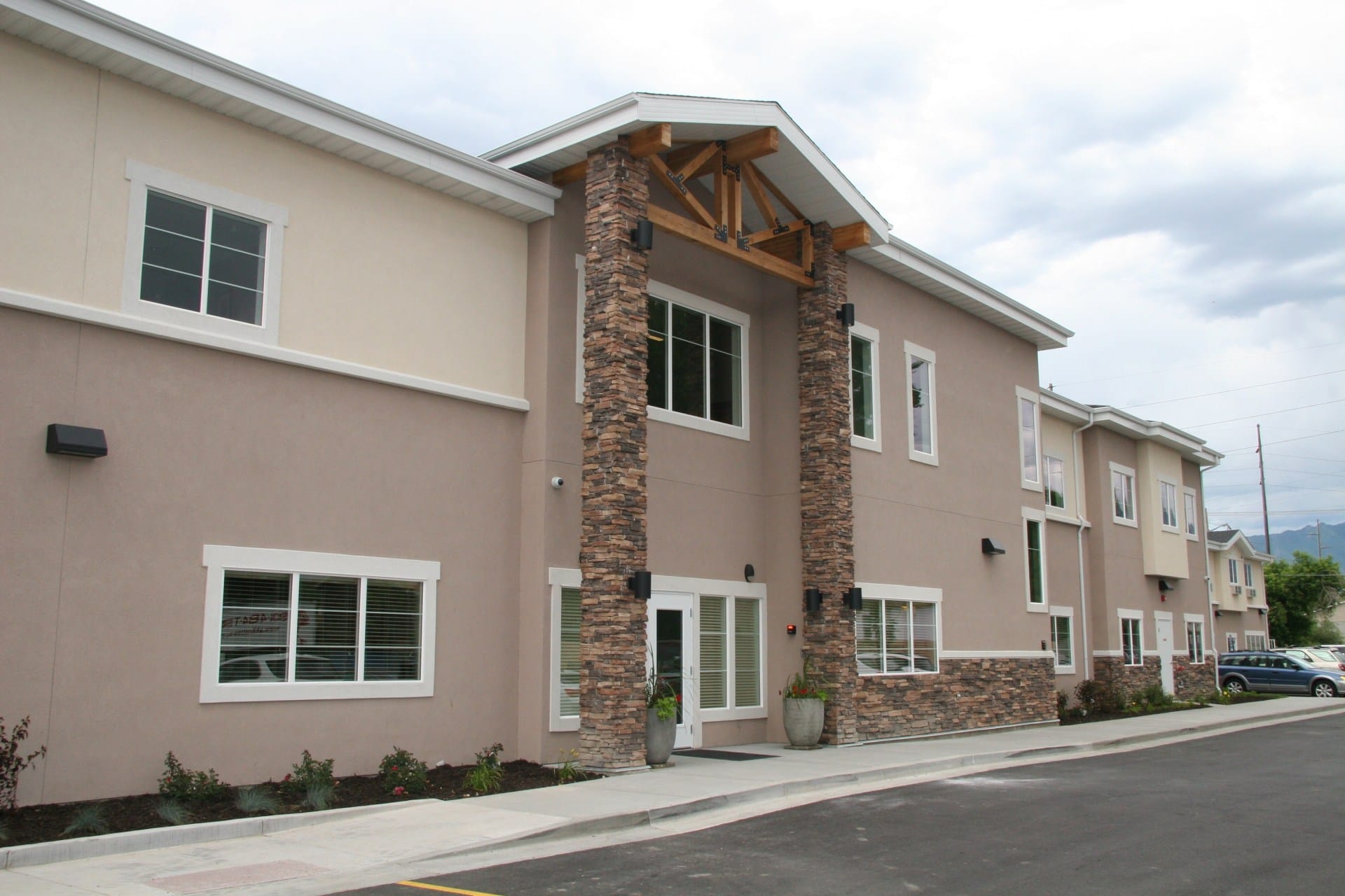 Exterior of two-story rehab facility with stone pillars
