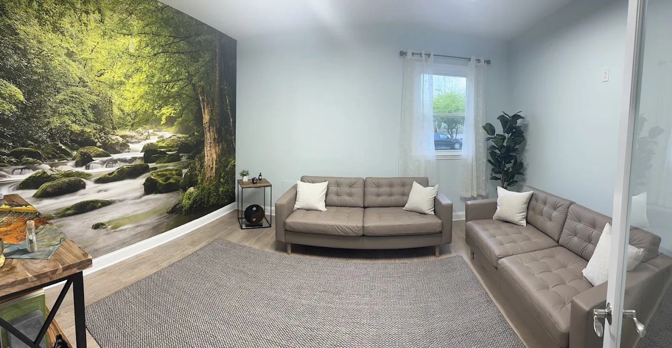 Relaxing lounge with leather sofas and forest mural wall