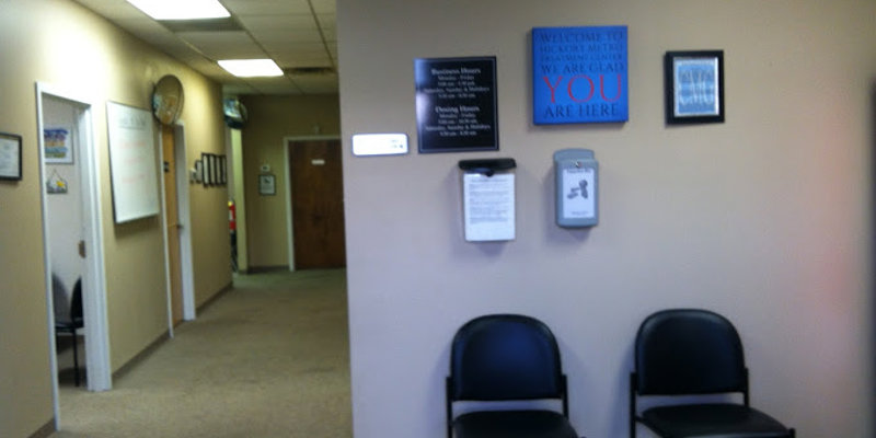  A welcoming waiting area with comfortable seating and informative signs on the wall, offering a calm and organized environment.