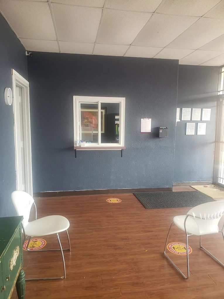 Clinic reception window with waiting chairs