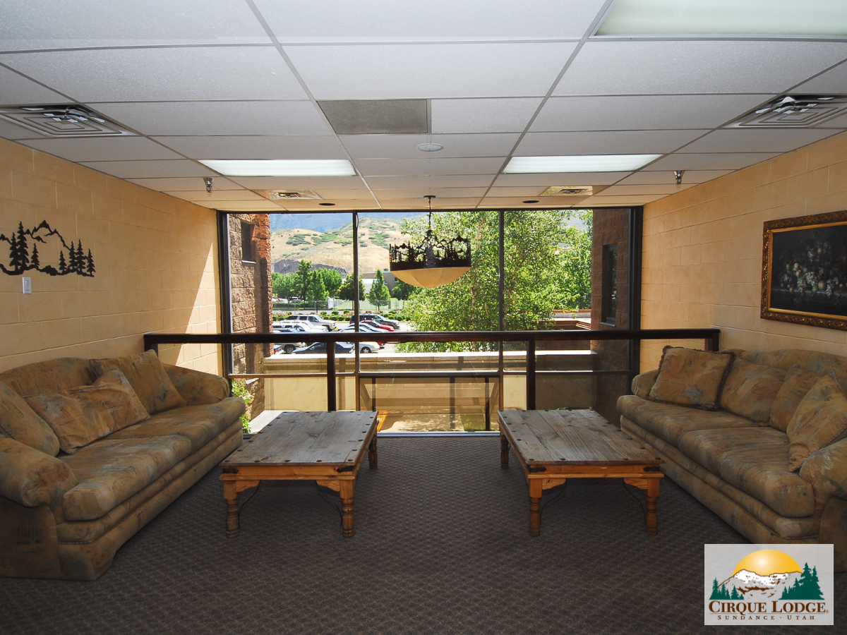 Cozy lounge with sofas and mountain views through large windows