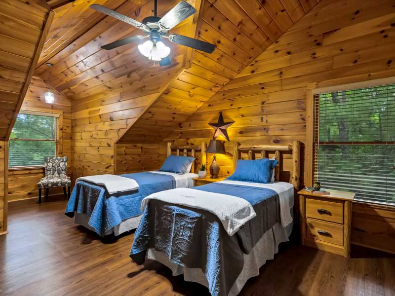 Cozy bedroom with two beds and natural wood walls