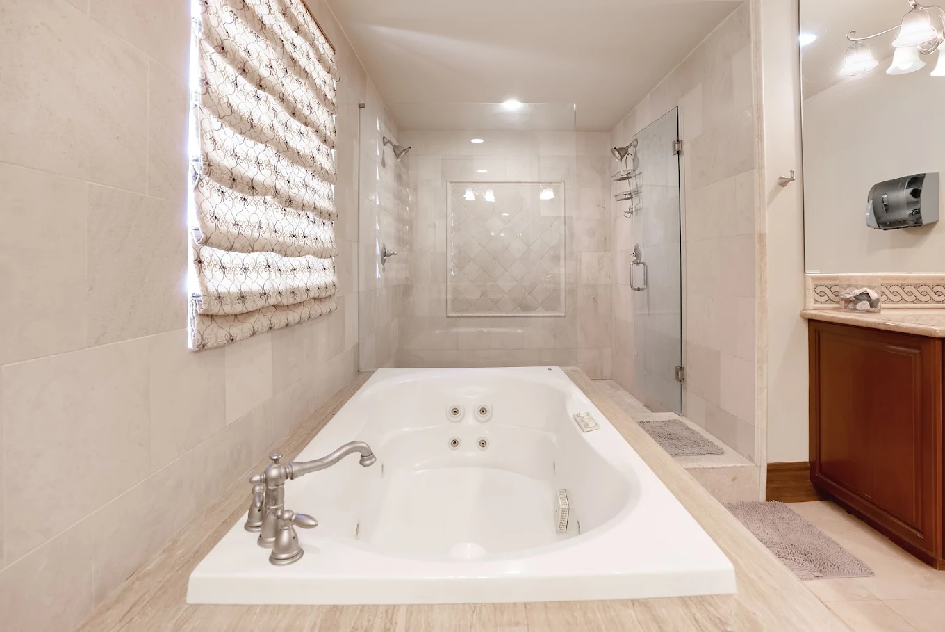 Bathroom with jetted tub and glass-enclosed walk-in shower