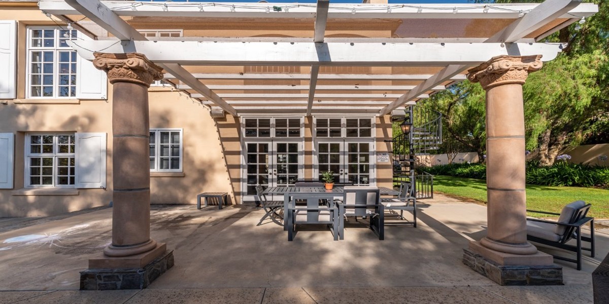 Patio with pergola, seating, and garden views