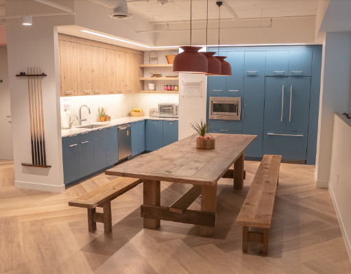 Shared kitchen with blue cabinets, island, and dining table