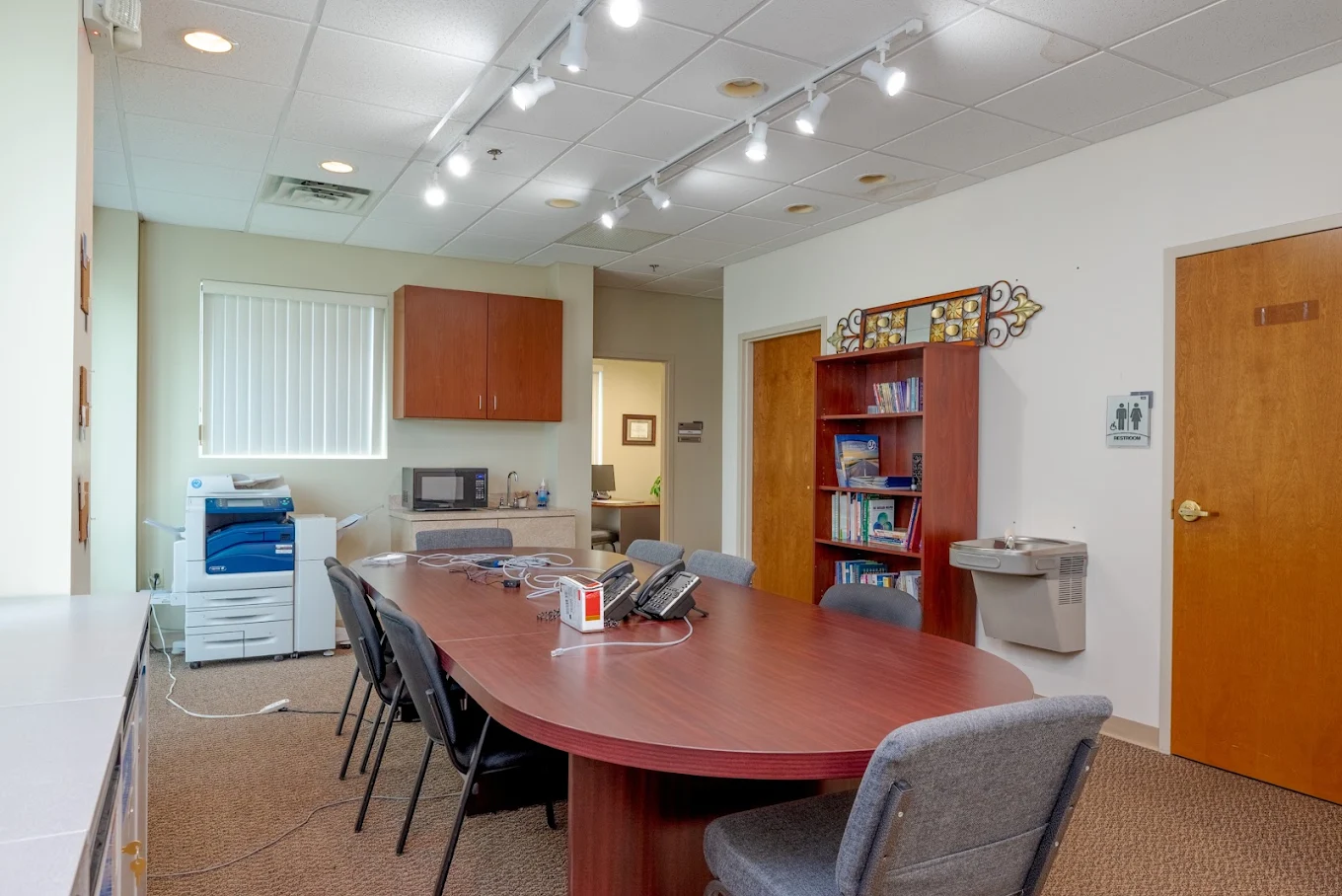 Group room with large conference table, chairs, and bookshelf