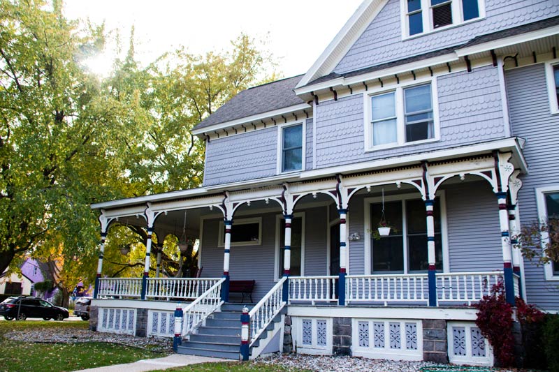 Large Victorian-style recovery home with wraparound porch