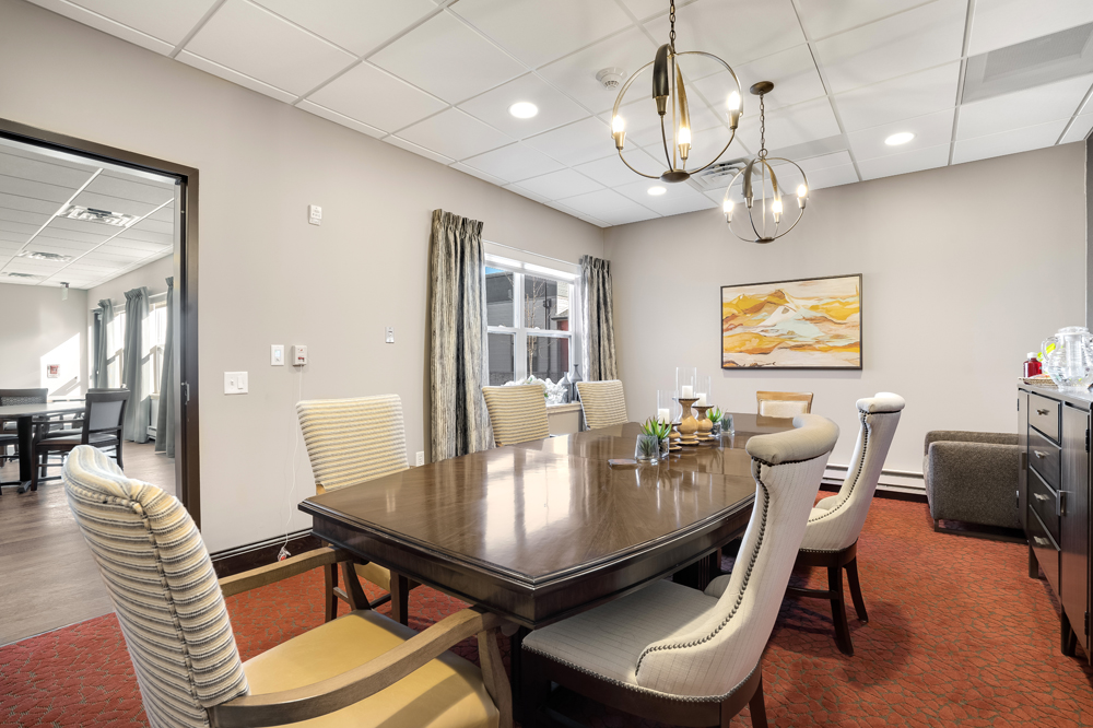 Private meeting room with large table and seating