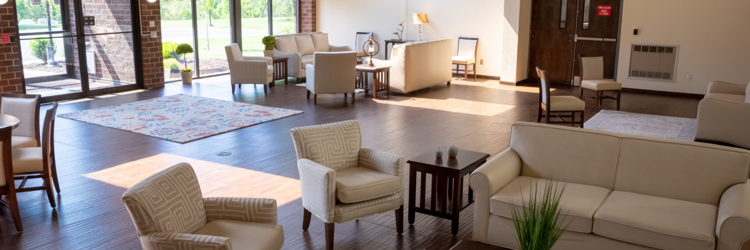 Lounge with soft seating and large windows for natural light