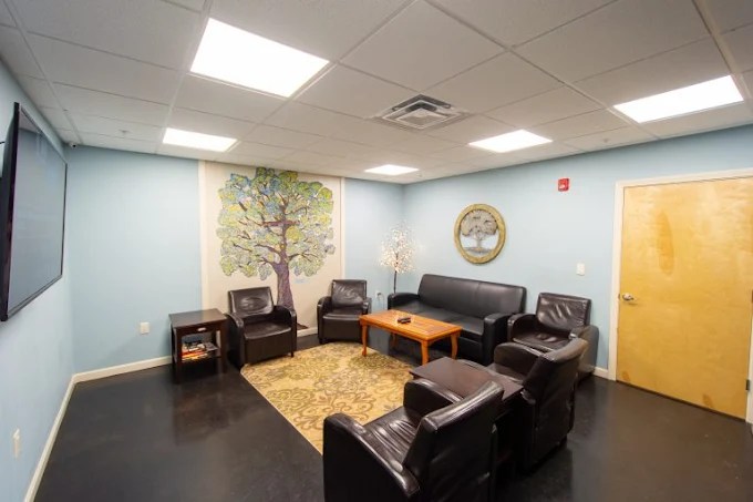 Therapy lounge with leather chairs and wall mural