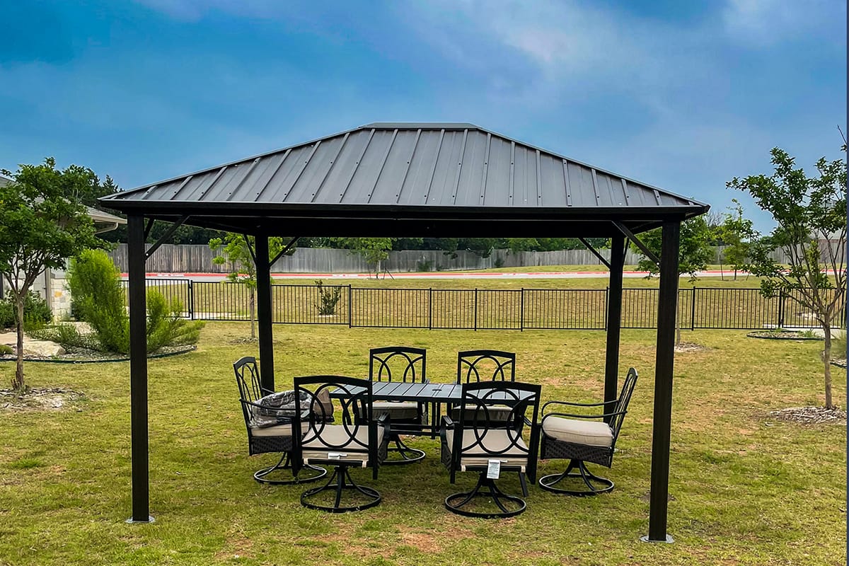 Outdoor seating area under a metal pergola.