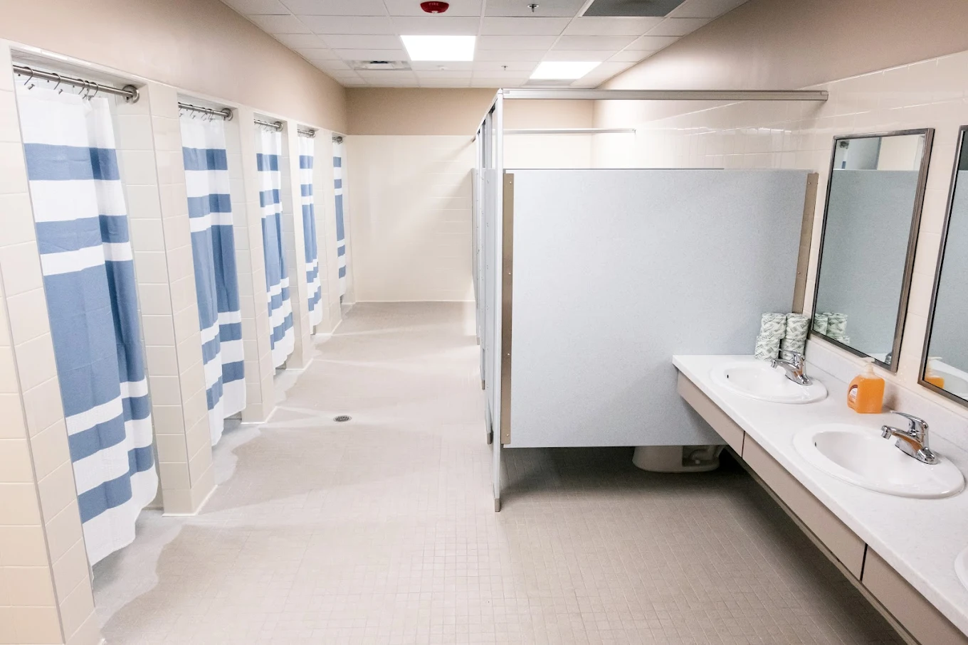 Shared bathroom with private showers and sinks