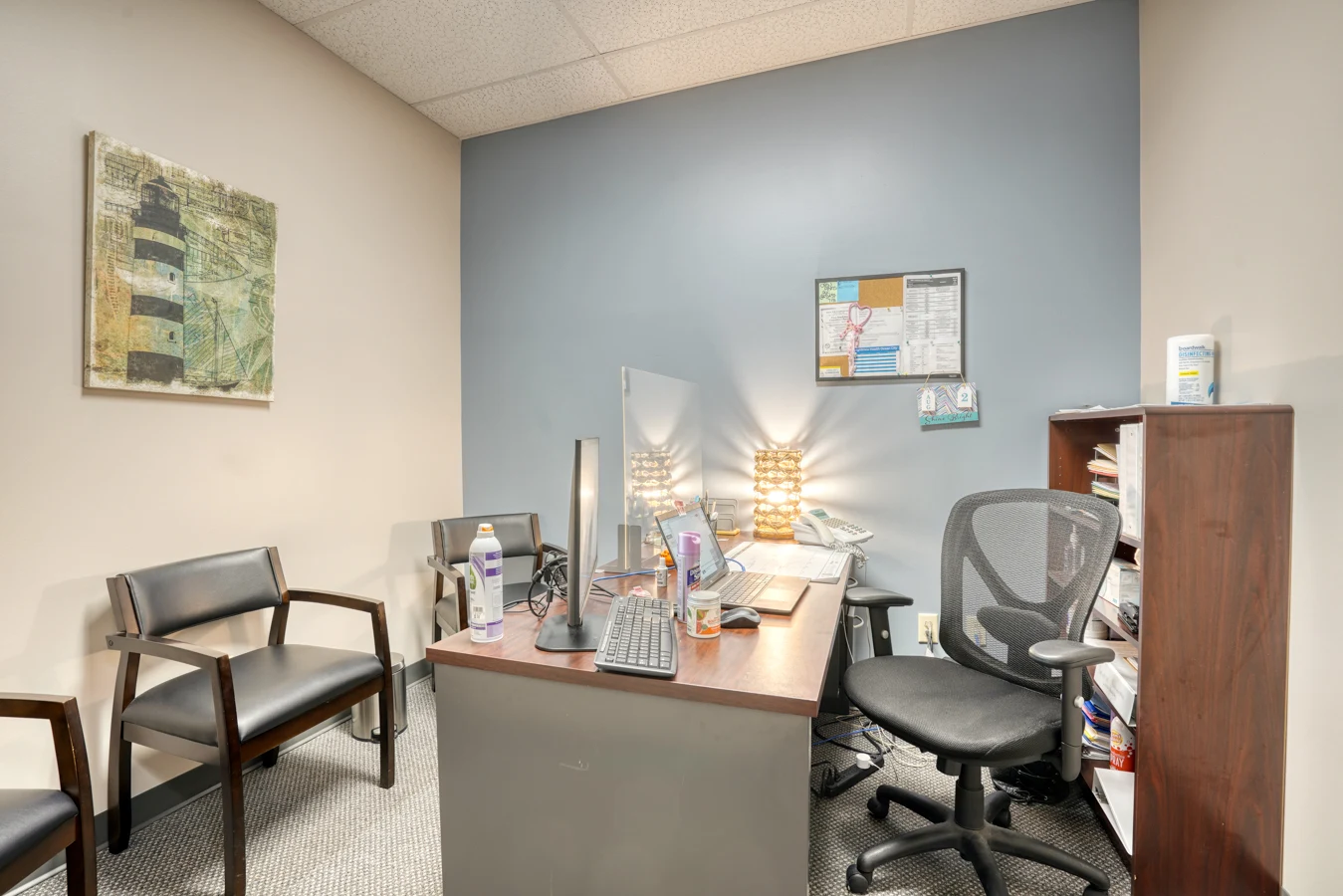Consultation office with computer workstation and guest chairs