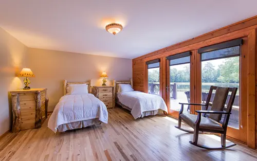 Shared bedroom with two beds and balcony access