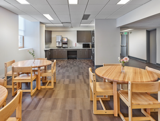 Small dining area with tables near kitchen counter